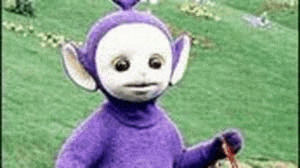 a purple and white teletubbies doll is standing in a field holding a red rope .