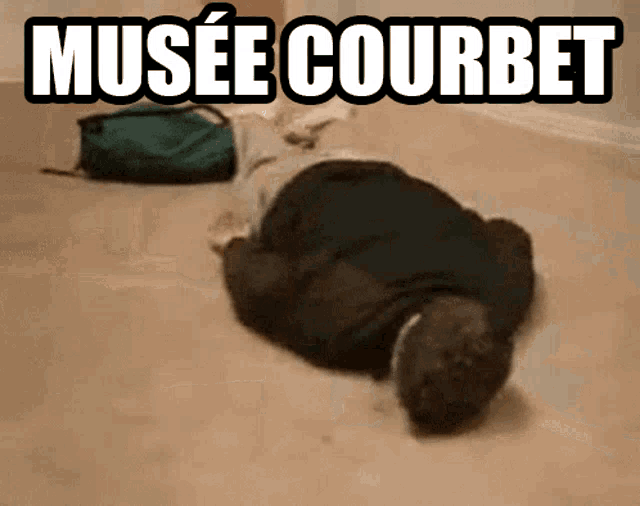 a man is laying on the floor with the words musee courbet written above him