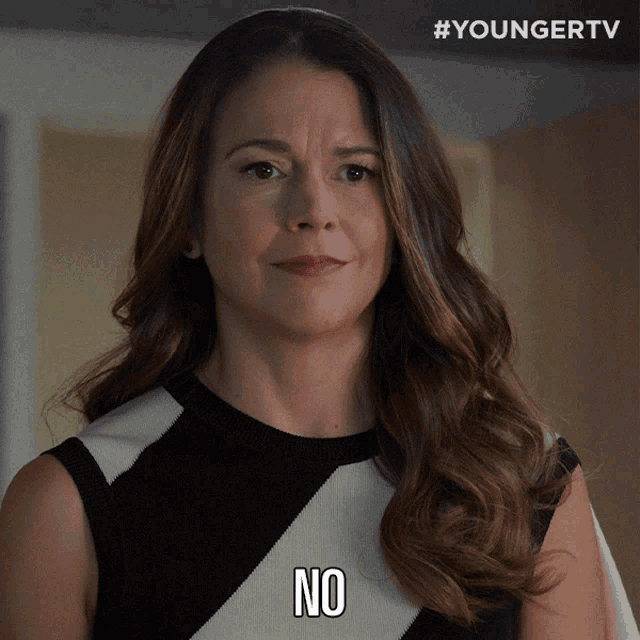 a woman in a black and white dress with the word no on her face