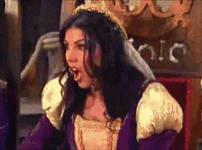 a woman in a purple and gold dress with a crown on her head is making a funny face