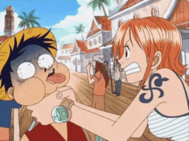 a woman with a tattoo of the letter s on her arm is holding a man 's face