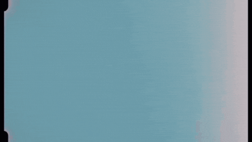 a blurred image of a blue sky with a few clouds in it