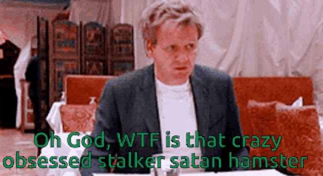 a man in a suit is sitting at a table with the words oh god wtf is that crazy obsessed stalker satan hamster