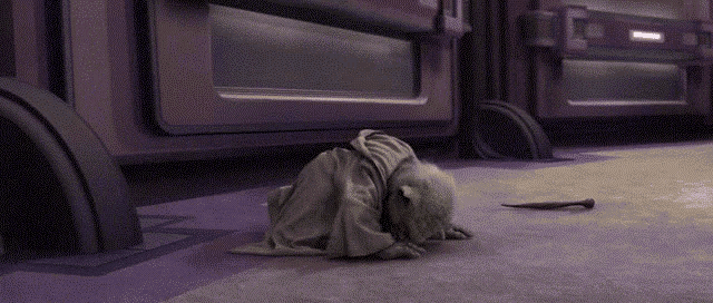 yoda from star wars is laying on the floor with a stick in his hand