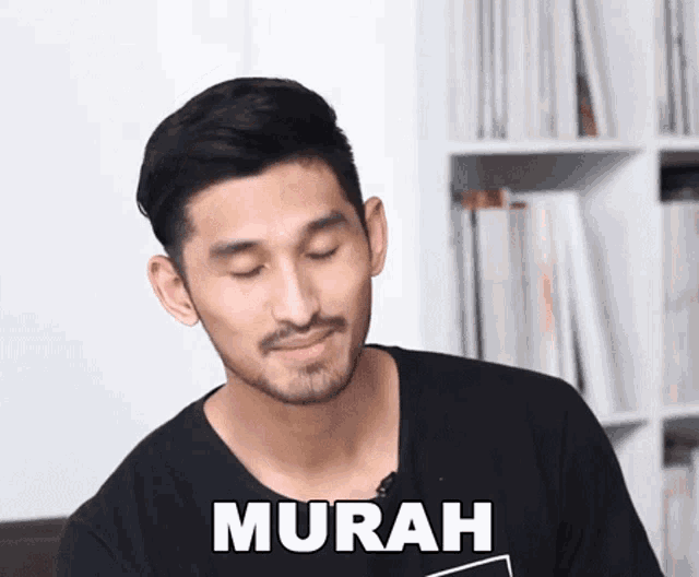 a man with a beard is wearing a black shirt with the word murah written on it