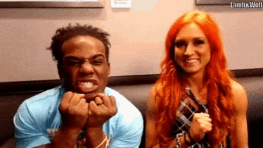 a man and a woman are sitting next to each other on a couch .
