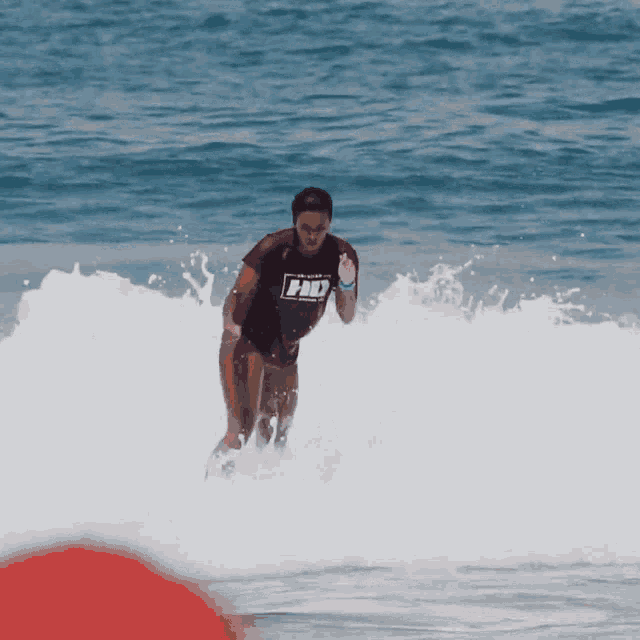 a person in the ocean wearing a shirt that says " pro "