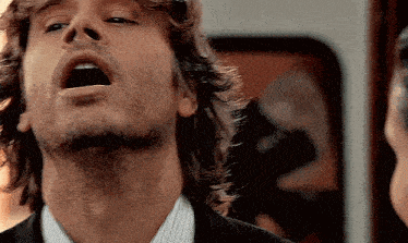 a close up of a man 's face with his mouth wide open