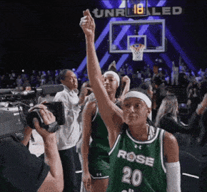 a female basketball player wearing a green jersey with the number 20
