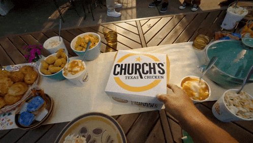 a box of church 's texas & chicken is on a table