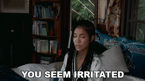 a woman is laying on a bed with the words you seem irritated written below her