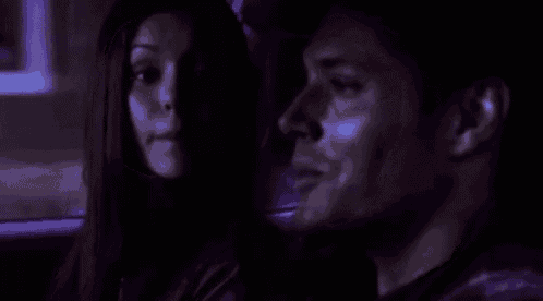 a man and a woman are sitting in the back seat of a car .