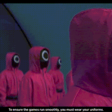 a large group of people are gathered in a room and one of them is talking to another man .