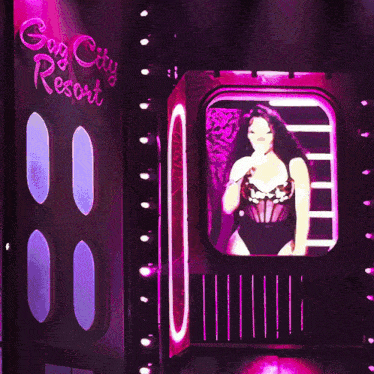 a woman in a swimsuit stands in front of a sign that says gas circle resort