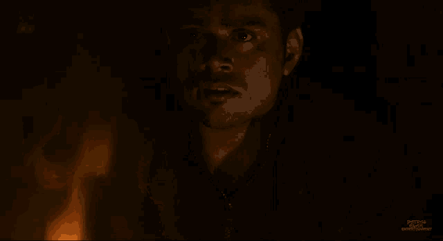 a man is standing in front of a fire with a watermark that says portland