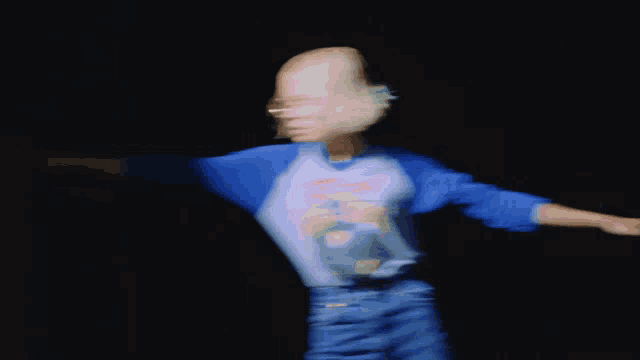 a blurry photo of a person wearing a shirt that says ' superman '