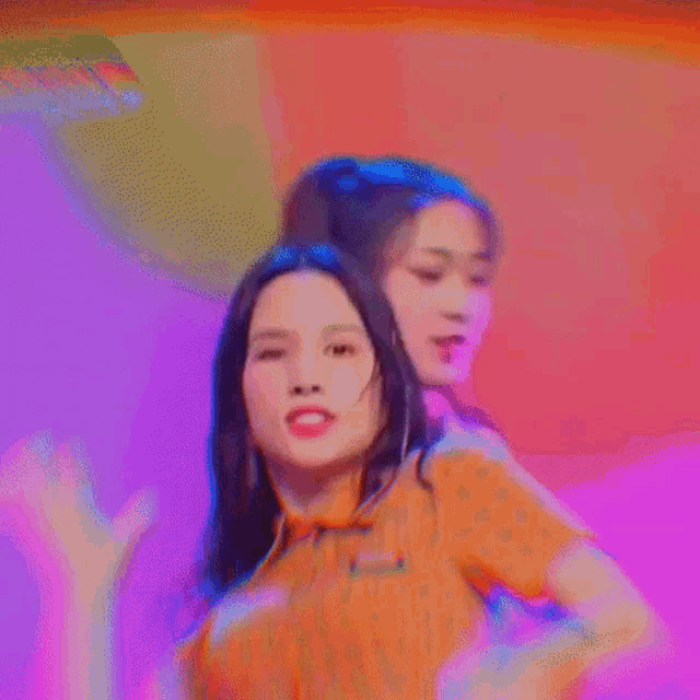 a woman is making a funny face while dancing on a stage in a blurry photo .