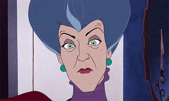 a cartoon character with blue hair and green eyes is looking at the camera .