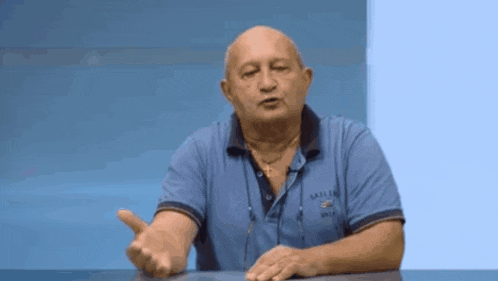a man wearing a blue shirt that says sailing on the front