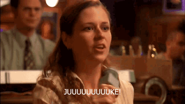 a woman is holding a can of beer and says jujuuuuuuuuke