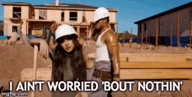 a man and a woman wearing hard hats on a construction site with the words i ain t worried bout nothin