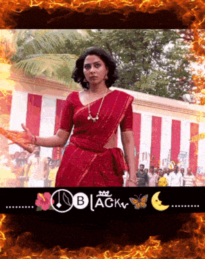 a woman in a red saree is surrounded by flames and the words " black "