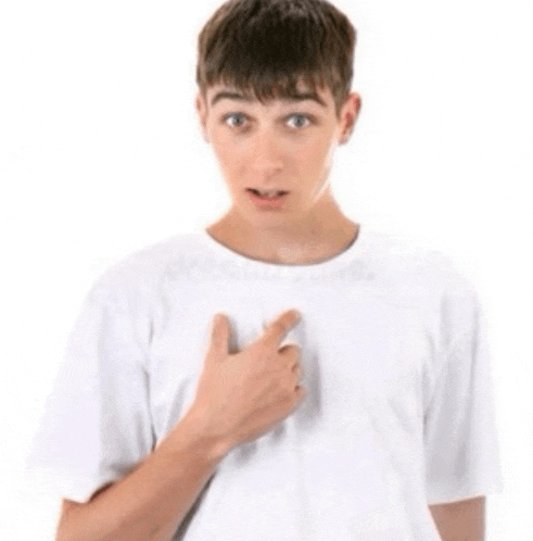 a young boy in a white shirt is pointing at his chest .