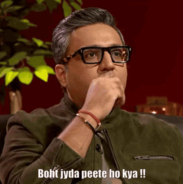 a man wearing glasses and a green jacket says boht jyda peete ho kya