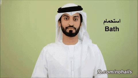 a man with a beard is wearing a white robe and a white head scarf ..