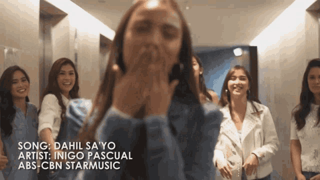a group of women standing in a hallway with the words song dahil sa yo artist inigo pascual abs cbn starmusic