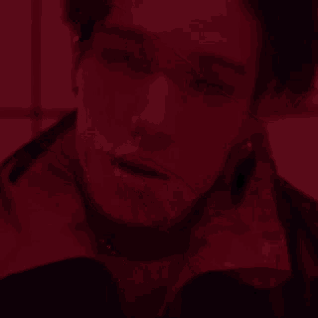 a close up of a person 's arm with a knife in a dark room .