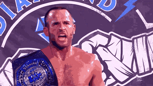 a man with a wrestling belt on his shoulder stands in front of a sign that says diamond