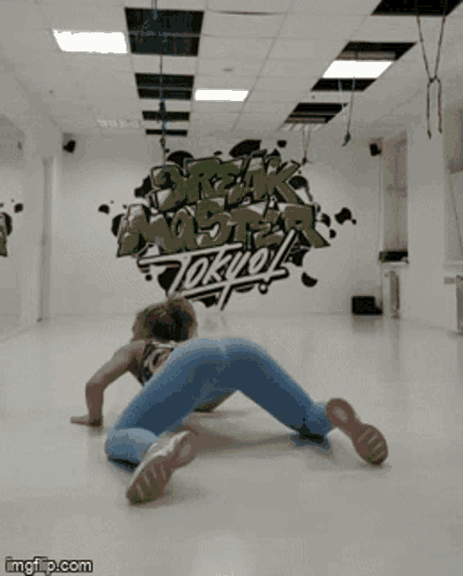 a woman is doing a trick in front of a sign that says " break monster tokyo "