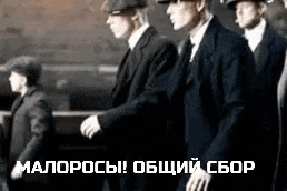 a group of men in suits and hats are walking in a row .