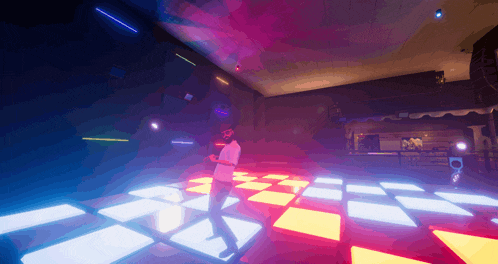 a man in a white shirt is dancing on a dance floor in a dark room