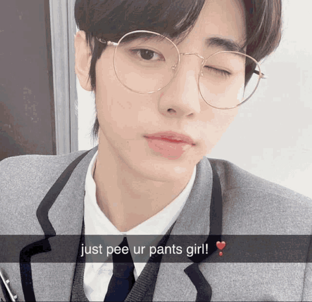 a young man wearing glasses and a suit says just pee ur pants girl ..