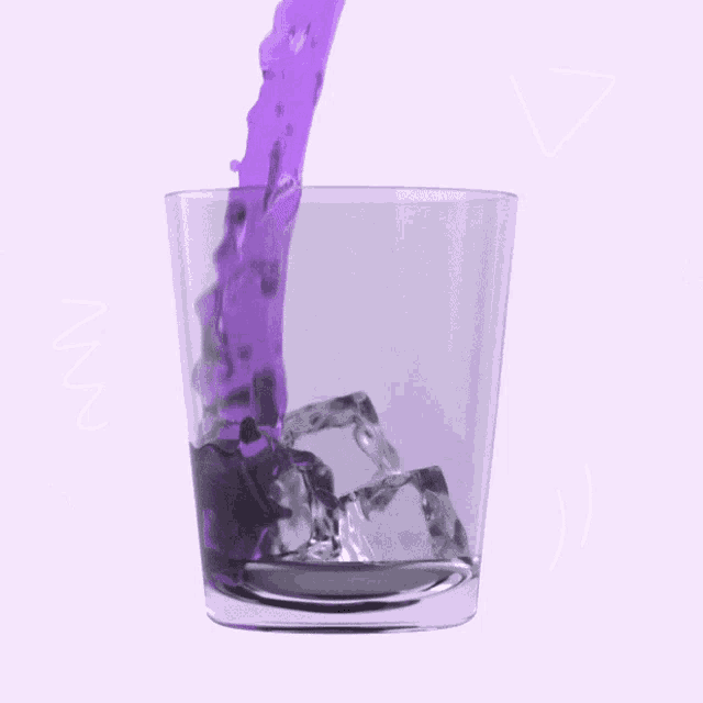 purple liquid is being poured into a glass with ice
