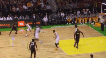a basketball game is being played on a court with jbl advertisements on the sidelines