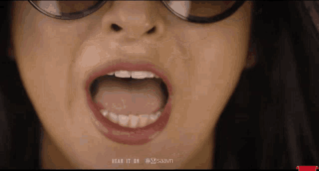 a close up of a woman 's mouth with the words " hear it on saavn " below it