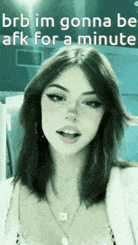 a girl with long hair and a necklace is wearing a white shirt and a sweater .