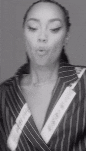 a black and white photo of a woman in a striped suit