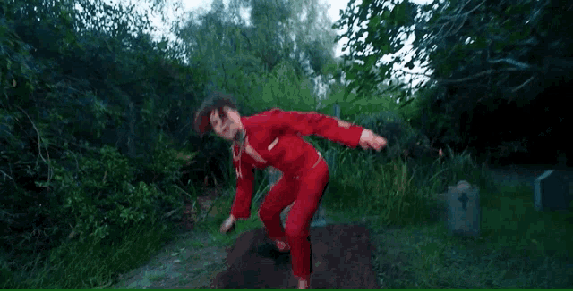 a man in a red suit with his arms outstretched
