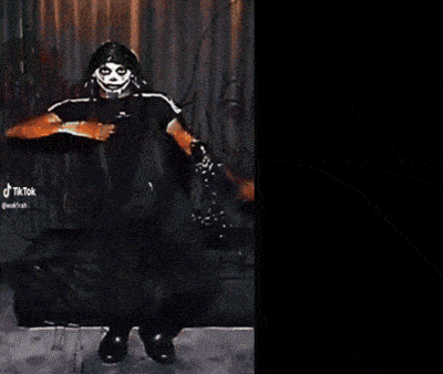 a black and white photo of a person with a skull mask
