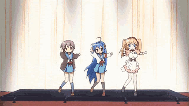 three anime girls are dancing on a stage and one has blue hair