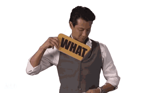 a man is holding a sign that says what on it
