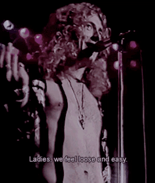 a man singing into a microphone with the words ladies we feel loose and easy