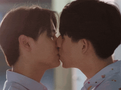 two men are kissing each other with their tongues hanging out