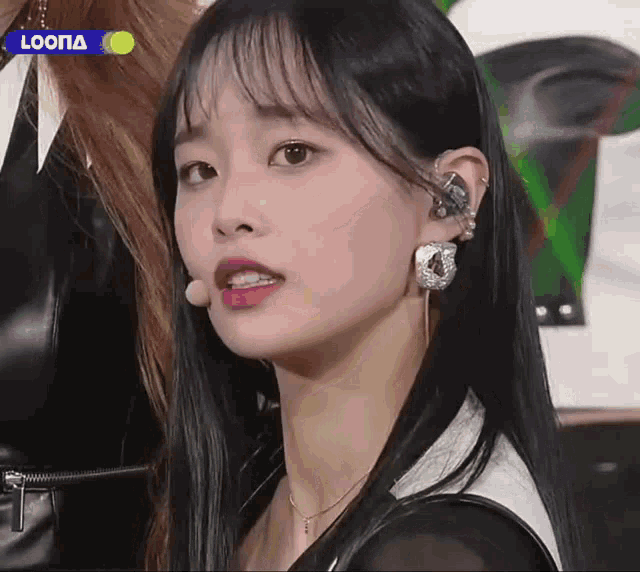 a close up of a woman 's face with the word loona on the bottom
