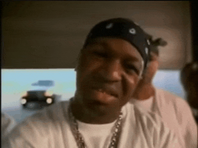 a man wearing a bandana and a white shirt