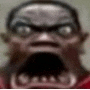 a close up of a man 's face with his mouth open and a beard .